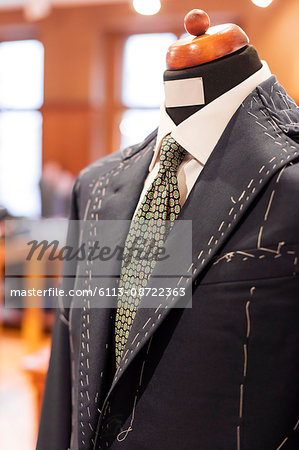 Close up tailored suit on dressmakers model in menswear shop