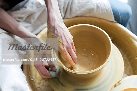 Overhead view woman using pottery wheel