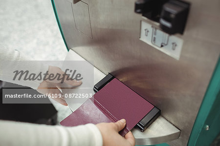 Traveller using self service check-in machine at airport