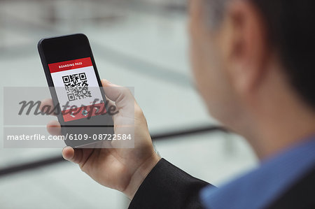 Business man using mobile phone in airport terminal