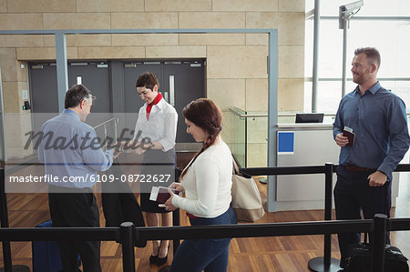 Businessman showing his boarding pass at the check-in counter in airport
