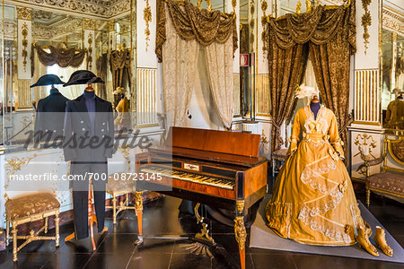 Room interior with piano and mannequins dressed in historical clothing at Donnafugata Castle in Ragusa in the province of Ragusa in Sicily, Italy