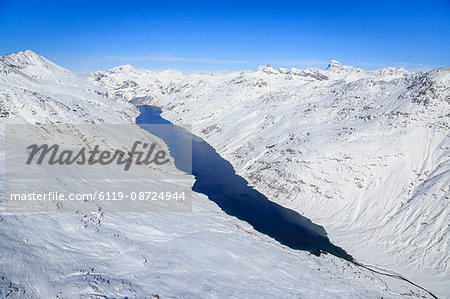 Aerial view of the alpine Lago di Lei surrounded by snow, Val di Lei, Chiavenna, Spluga Valley, Valtellina, Lombardy, Italy, Europe