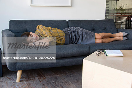 Business relaxing on a couch during office break