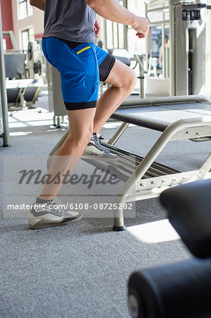 Low section view of a man exercising in a fitness club