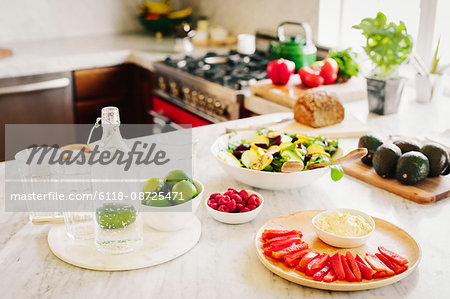 A choice of prepared fresh salads on a kitchen counter.