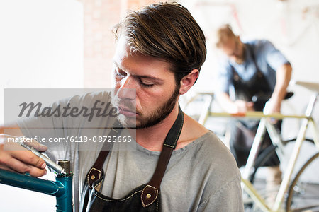 A man working in a bicycle repair shop.