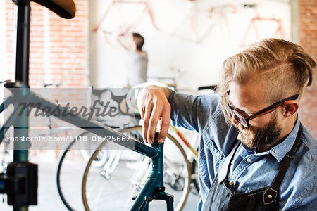 A man working in a bicycle repair shop.