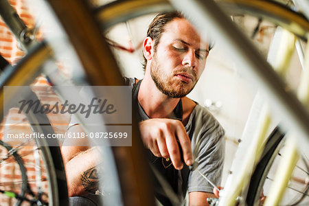 A man working in a bicycle repair shop.