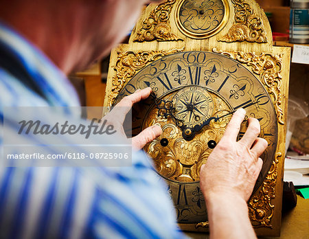 A clock maker displaying his work.