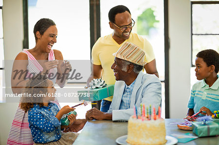 Senior man celebrating his birthday with his family.