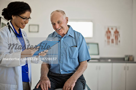 Smiling senior man receiving good news at his annual medical check up.