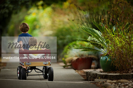 Happy young boy running down a shopping street.