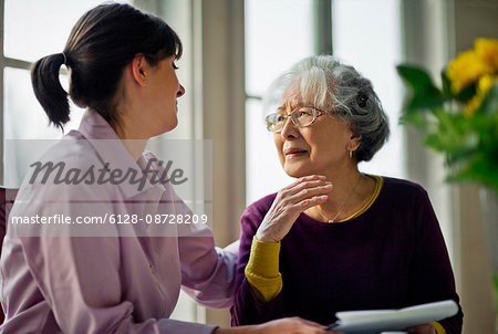 Elderly woman speaking with her doctor. Elderly woman speaking with her doctor.