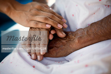 Grandmother being consoled by grandaughter.