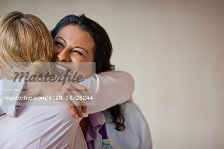 Doctor hugging patient who has received good news.