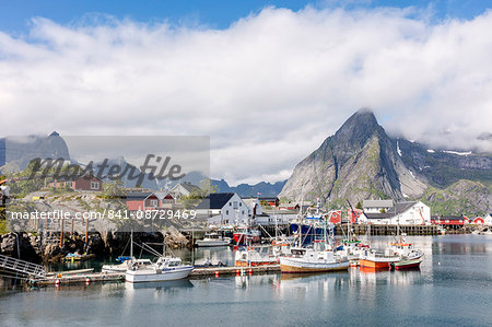 Fishing village and harbour framed by peaks and sea, Hamnoy, Moskenes, Nordland county, Lofoten Islands, Arctic, Northern Norway, Scandinavia, Europe