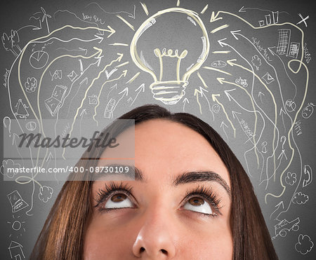 Woman with light bulb and business drawings above her head