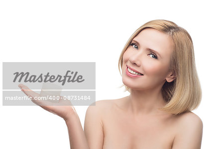 Beautiful middle aged woman with smooth skin and short blond hair holding moisturizing cream. Beauty shot. Isolated over white background. Copy space.