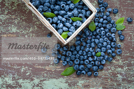 Top view of blueberries with green leaves