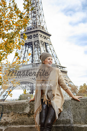 Autumn getaways in Paris. smiling young elegant woman on embankment in Paris, France exploring attractions