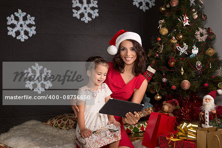 Smiling and happy family with tablet pc. Christmas decoration