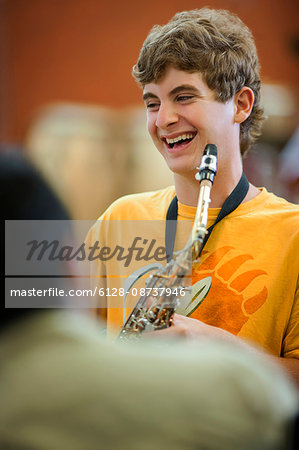 Teenage boy learning to play saxophone.