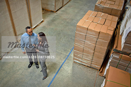 Man and woman working in warehouse.