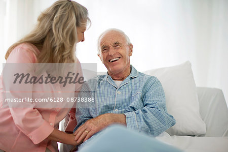 Smiling mature woman laughing with her senior husband.