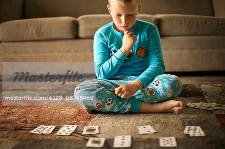 Young boy playing a card game.