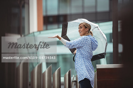 Beautiful woman enjoying rain during rainy season