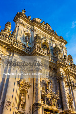 Baroque facade of the Church of Saint John the Baptist against a blue sky in Lecce in Puglia, Italy