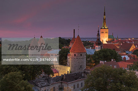 Medieval town walls, defence towers and spire of St. Olav's church at sunset, Tallinn, Estonia, Baltic States, Europe