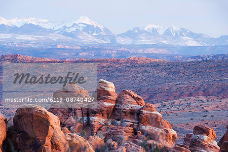 Rock formations at the Fiery Furnace, and snow capped mountains of Manti-La Sal National Forest, at Arches National Park, Utah, United States of America, North America