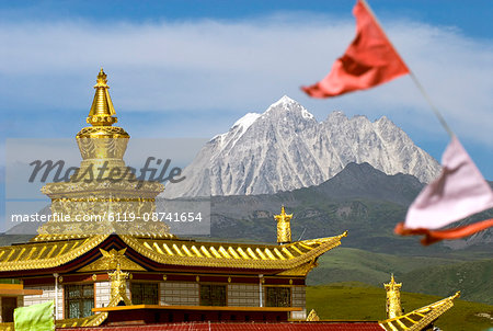 Snow mountain and Buddhist temple, Tagong Grasslands, Sichuan, China, Asia