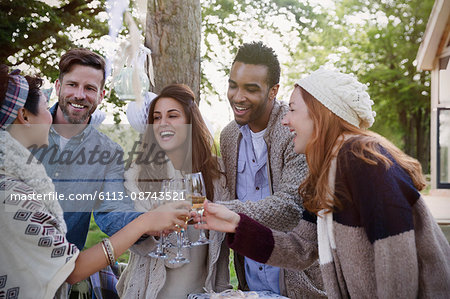 Friends toasting champagne glasses on patio