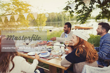 Friends enjoying lunch at lakeside patio table