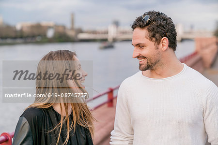 Happy young couple on waterfront, Battersea Park, London, UK