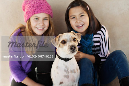 Portrait of two girls with dog