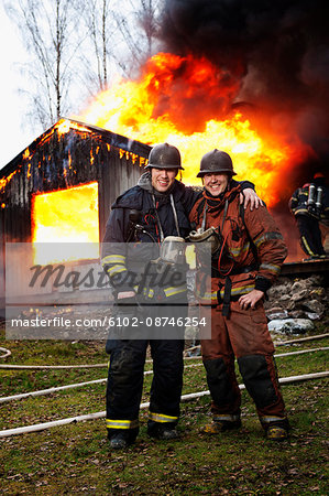 Fire fighters in front of burning buildings