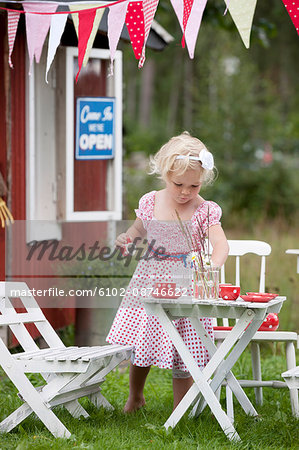 Girl playing in front of playhouse