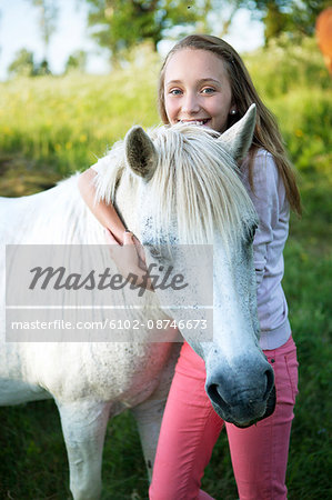 Smiling girl with horse