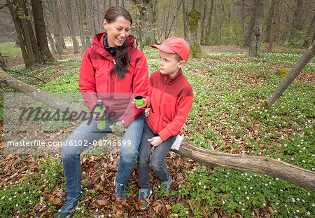 Mother with son resting in forest