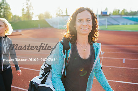 Smiling woman on running track