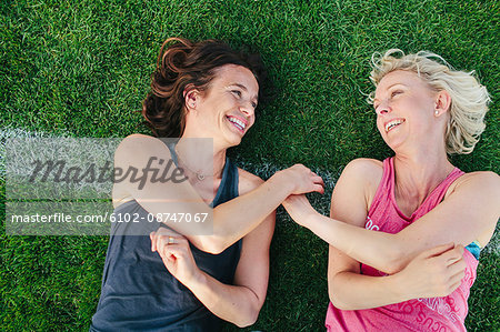 Female friends on grass pitch Female friends on grass pitch