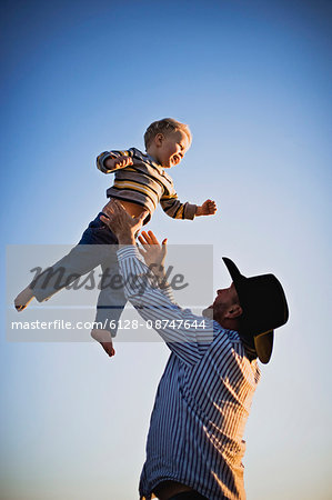 Father throwing his son in the air