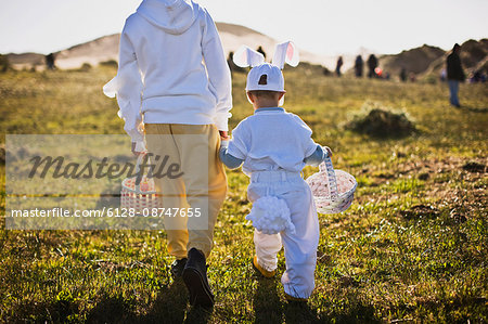 Two brothers in Easter costumes on an Easter egg hunt