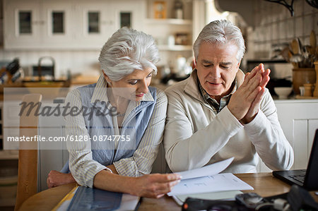 Mature couple working on their finances together.