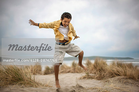 Young boy enjoying day at beach.