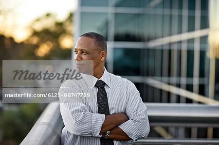 Businessman standing on his office balcony.